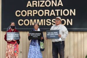 Black Mesa residents holding signs in front of ACC