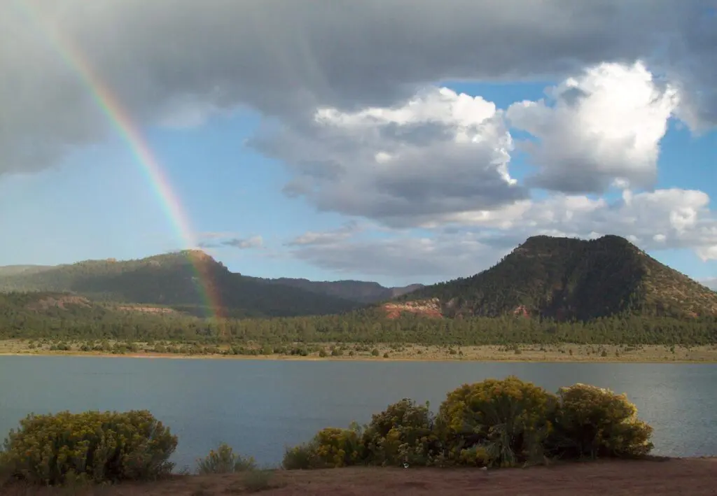 A rainbow over a lake.