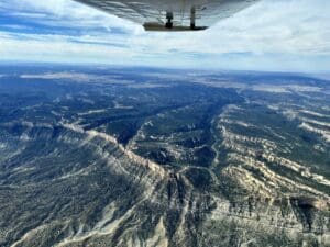 A view from the wing of a plane over a canyon.