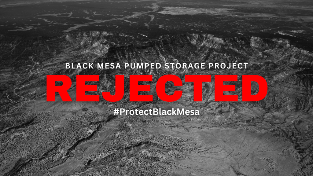 Aerial view of black mesa with the text "rejected" over it and the hashtag "#protectblackmesa" as part of a campaign against the pumped storage project.