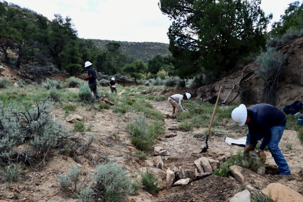 Watershed crew members building one-rock dams in the Twin Valley wash.