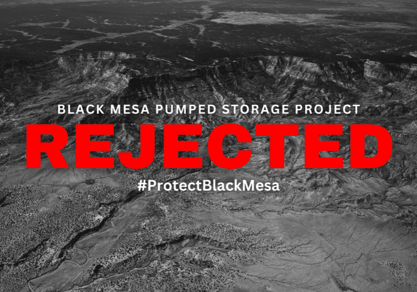 Aerial view of black mesa with the text "rejected" over it and the hashtag "#protectblackmesa" as part of a campaign against the pumped storage project.