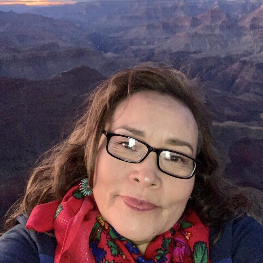 A woman taking a selfie in front of the grand canyon.